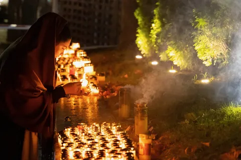 Woman lighting candles, Romania — Nicolas Marincic