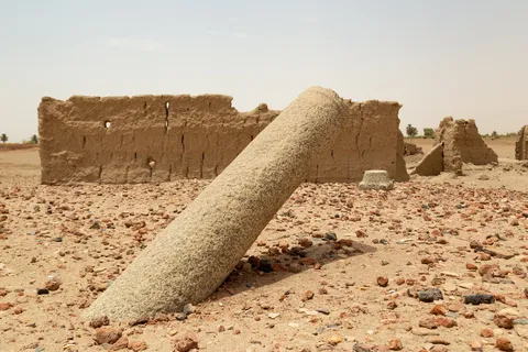 Fallen granite column before mud-brick ruins, Nubia, Sudan — Nicolas Marincic