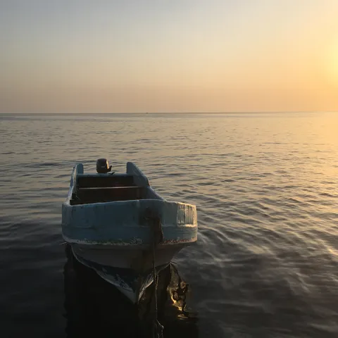 Boat on a calm Red Sea at sunrise, Port Sudan, Sudan — Nicolas Marincic