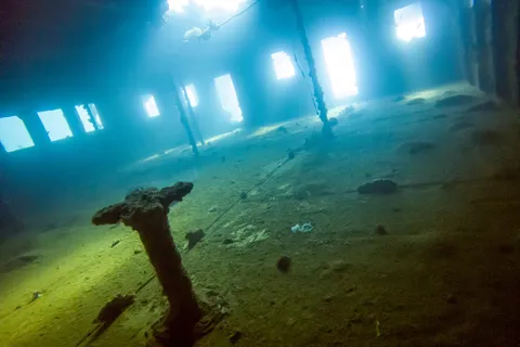 Light filtering into a wreck’s hold, Sudan — Nicolas Marincic