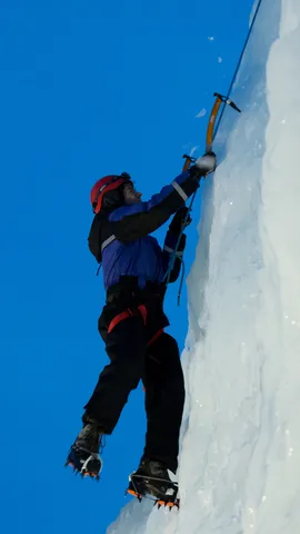 Ice climber against a deep blue sky, Abisko, Sweden — Nicolas Marincic