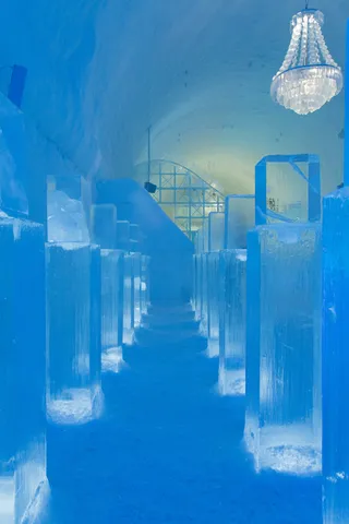 Blue ice corridor and chandelier, Icehotel, Sweden — Nicolas Marincic