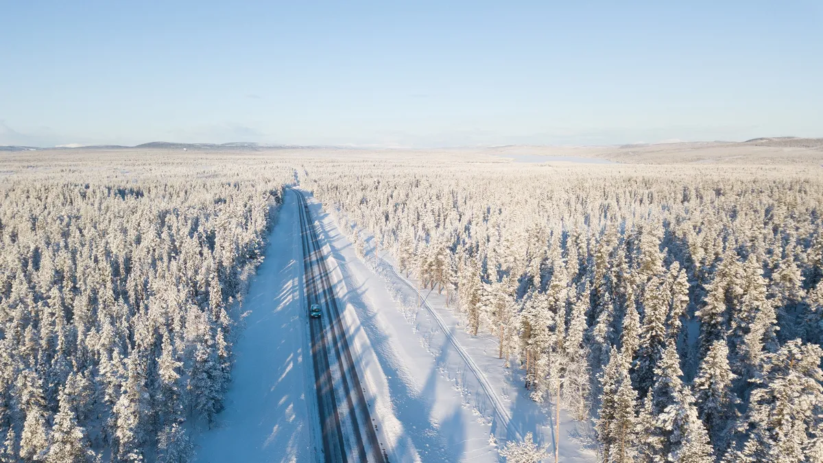 Road through frosted taiga, aerial view, Sweden — Nicolas Marincic
