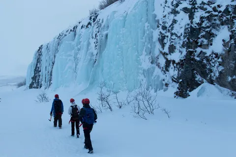 Walkers below a frozen waterfall, Sweden — Nicolas Marincic