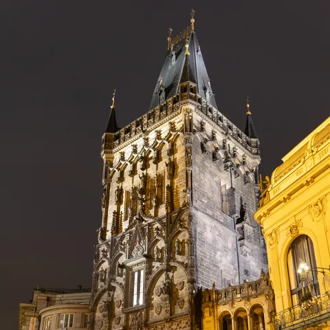 Powder Tower lit at night, Prague, Czechia — Nicolas Marincic