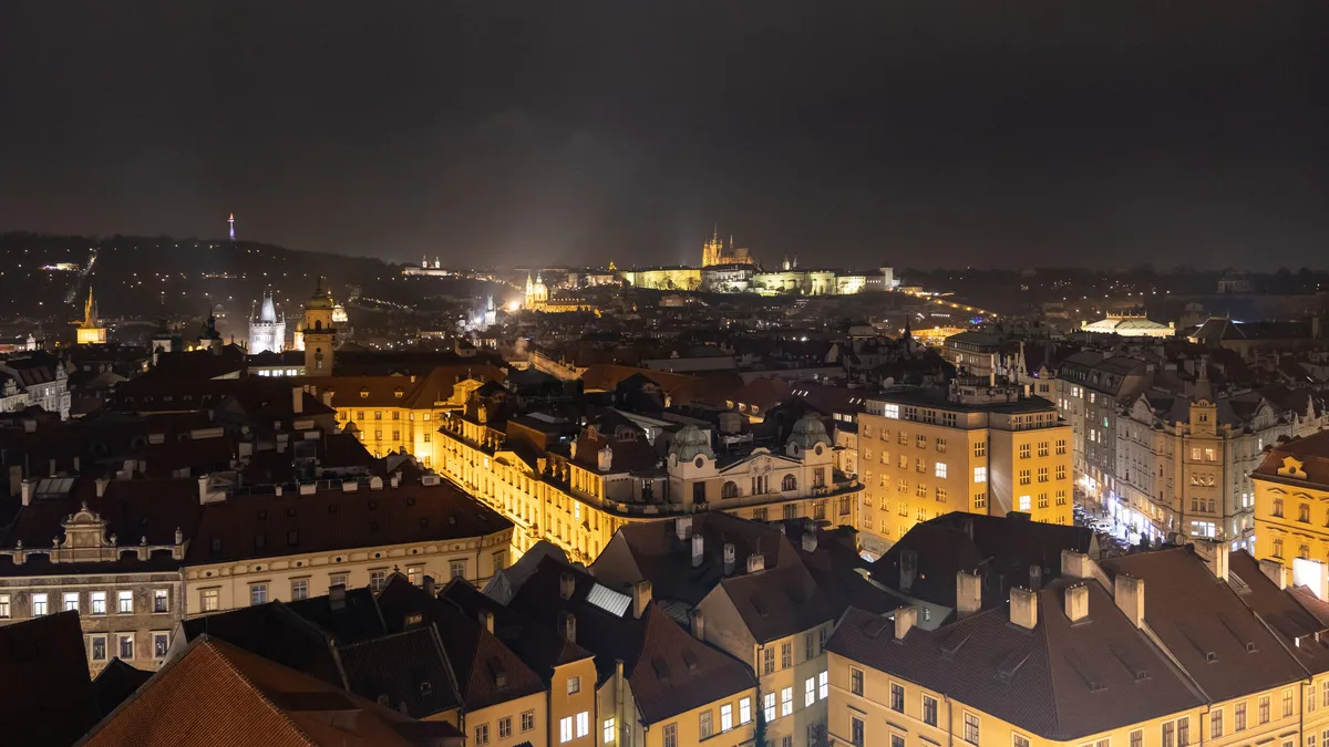 Prague at night from the Old Town Hall tower, castle beyond, Czechia — Nicolas Marincic