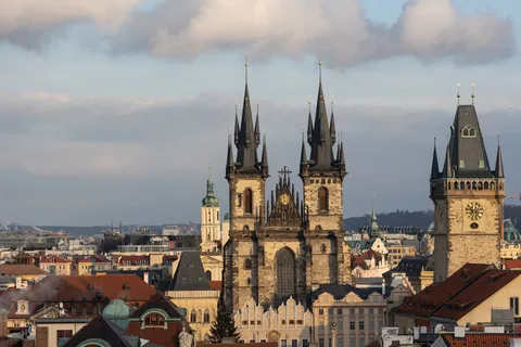 Týn Church and Old Town Hall towers above the rooftops, Prague, Czechia — Nicolas Marincic