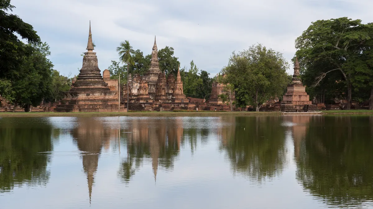 Wat Mahathat reflected in the pond, Sukhothai, Thailand — Nicolas Marincic