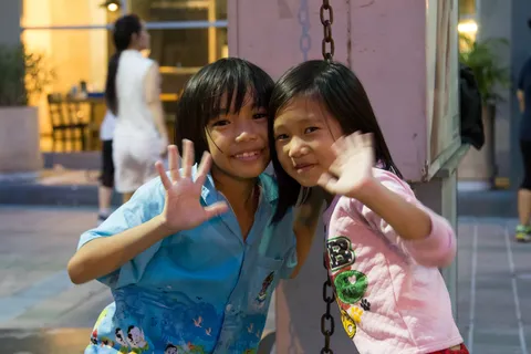 Girls waving at the camera, Thailand — Nicolas Marincic