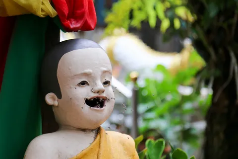 Child statue with a chipped face, Thailand — Nicolas Marincic