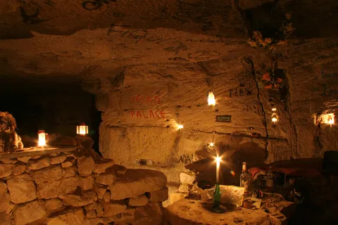 Candle-lit quarry chamber beneath Paris, France — Nicolas Marincic