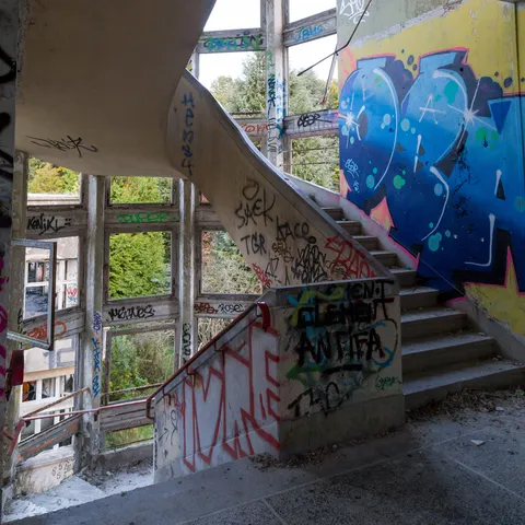 Graffitied spiral staircase, abandoned sanatorium, France — Nicolas Marincic