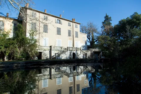 Abandoned château mirrored in its pond, France — Nicolas Marincic