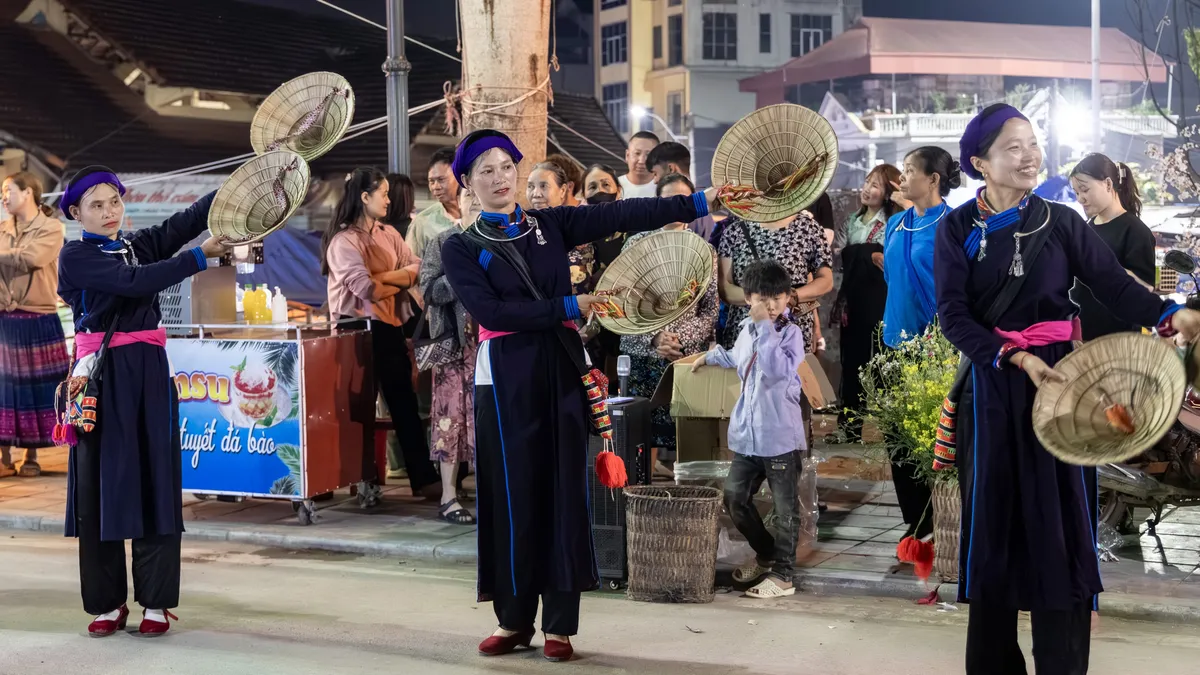 Dao women in conical hats at a night market, Vietnam — Nicolas Marincic