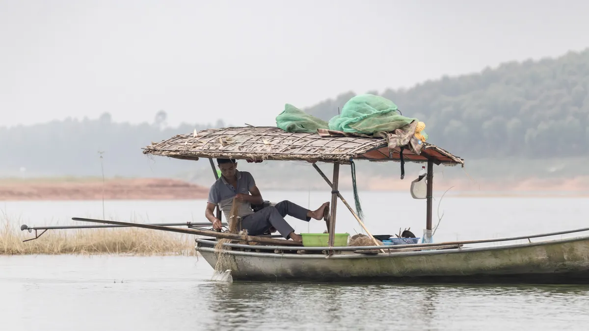 Fisherman in a canopied boat, Vietnam — Nicolas Marincic